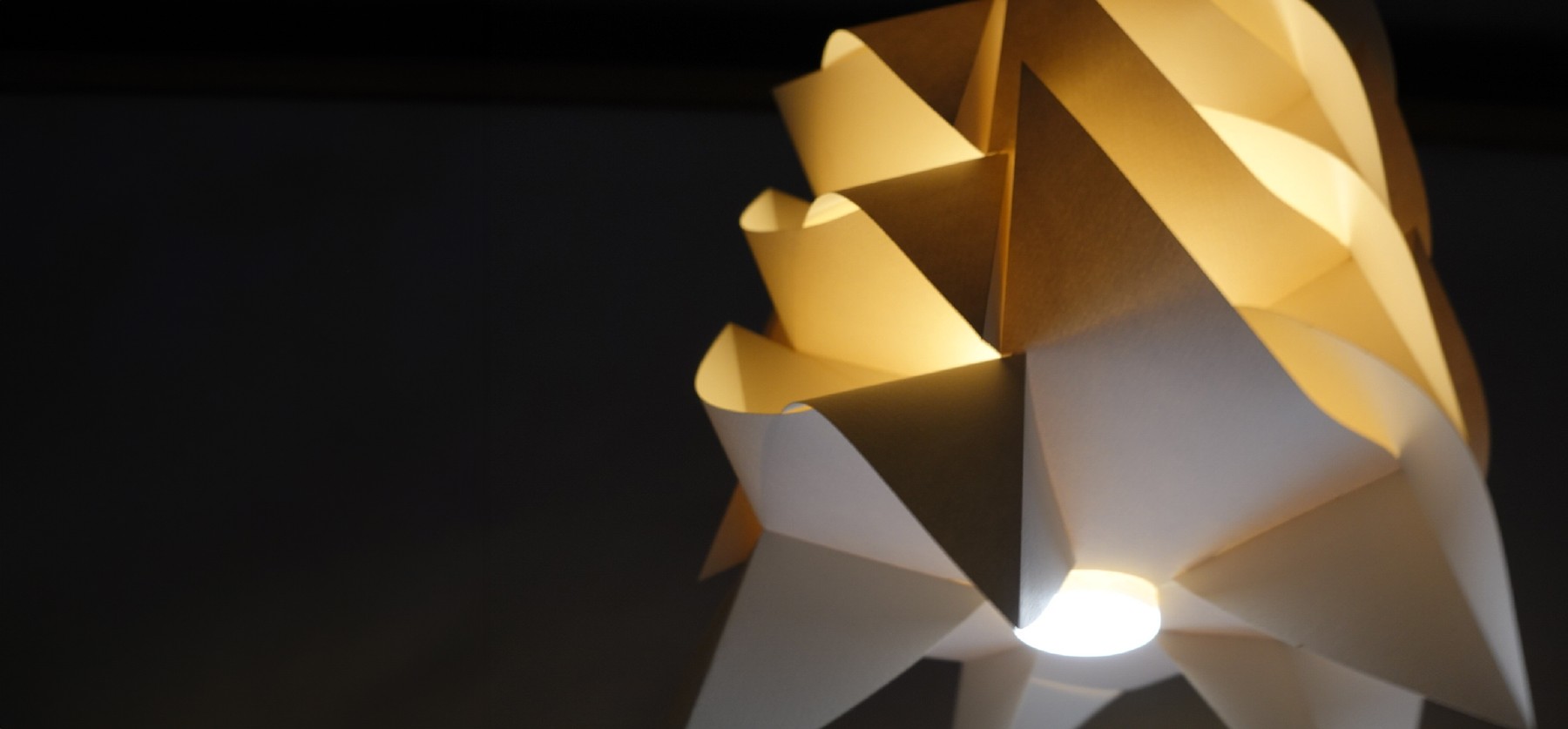 Bottom view of the illuminated folded IGNIS luminaire